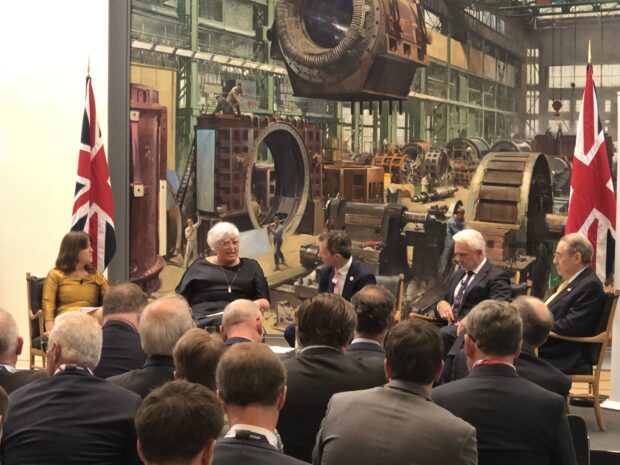 A room of people are looking on at a panel featuring Gwen-Parry Jones, Interim CEO of Great British Nuclear, speaking at the Great British Nuclear launch event.
