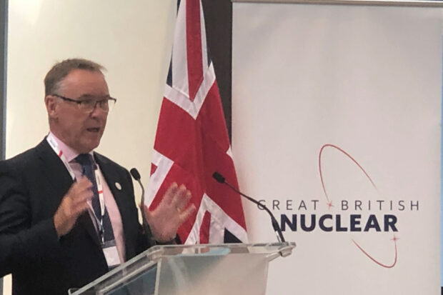 Simon Bowen, Great British Nuclear Chair, stands at a podium, addressing attendees at the Great British Nuclear launch event.